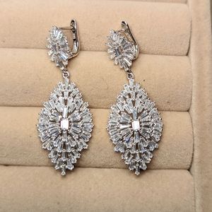 Baguette cut cubic zirconia and rhodium plated sterling silver earrings.